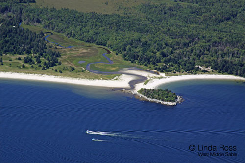 Fishing boats motoring by the Wombemkak (left) and Carter's (right) beaches.